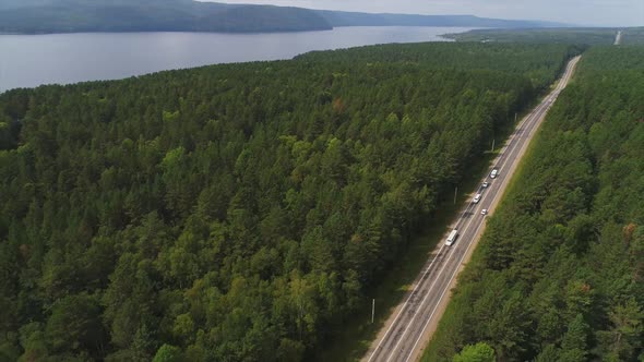 Beautiful Aerial View of Green Forest and Cars Traveling on Road on Summer alt