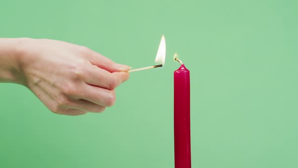 Hand firing a candle alt