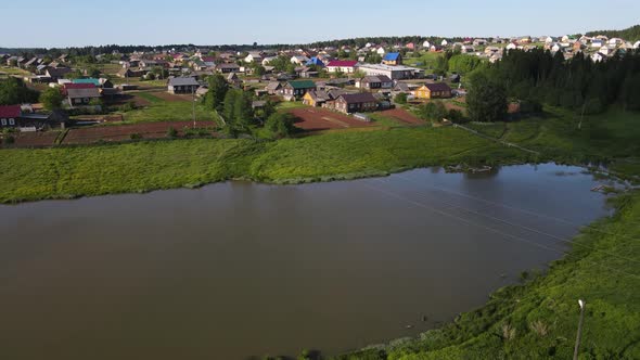 Houses Near River in Small Township on Sunny Day