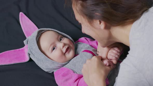 Closeup. Mother Gently Kissing Baby Enjoying Loving Mom Playfully Caring for Toddler at Home Sharing alt