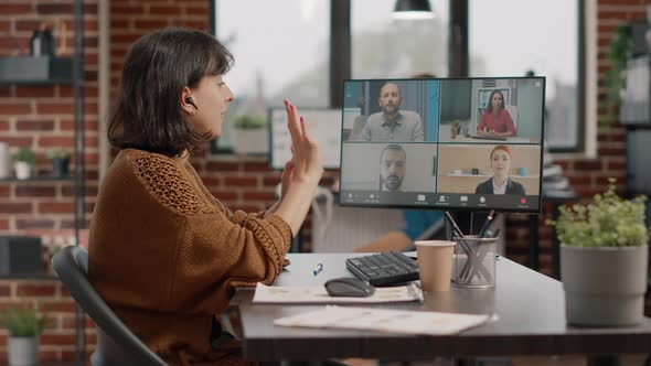 Entrepreneur Using Video Call on Computer to Talk to Colleagues alt