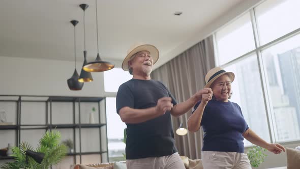 asian senior happiness couple home isolation concept,asian old retired adult couple dancing together