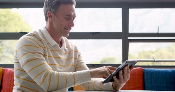 Male teacher using digital tablet alt