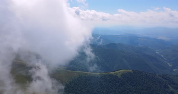 Flight Over Mountains Covered With Dense Forests And Thick Fog