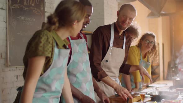 Chef Giving Cooking Class to Diverse Students alt