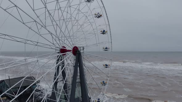 Ferris Wheel in Closed Beach Amusement Park on Stormy Day