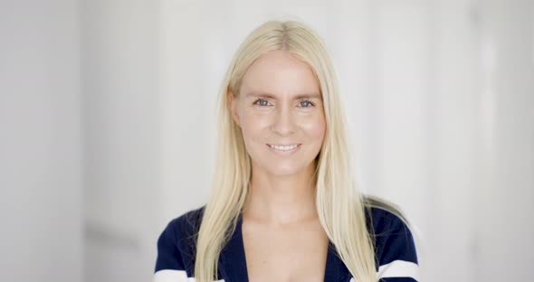 Portrait of smiling blond woman alt