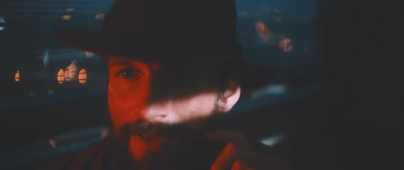 Close up of man waving through shutter and red lights using vintage camera alt