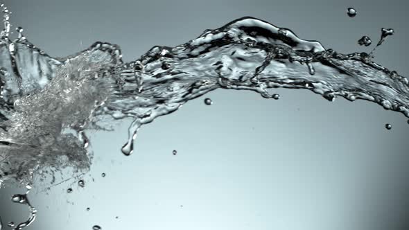 Super Slow Motion Shot of Water Splash at 1000Fps on Blue Gradient Background. alt