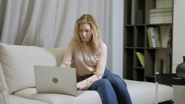 young freelancer works at home and uses a computer for communication and online alt