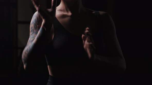 A Tattooed Woman Showing Karate Fighting Hands Moves alt