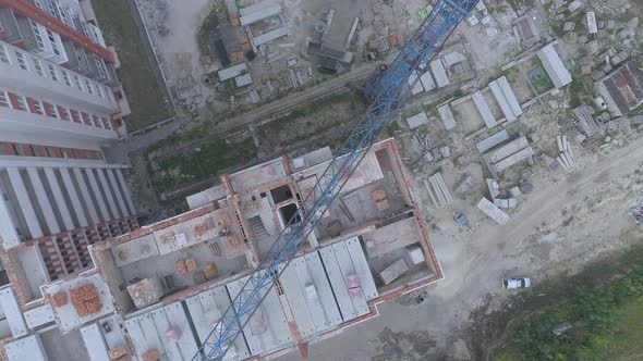 Aerial view of blocks and crane on a construction site alt