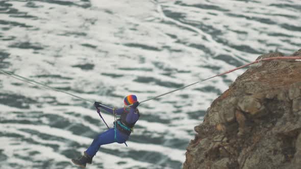 Climber Crossing the Gorge on a Rope.