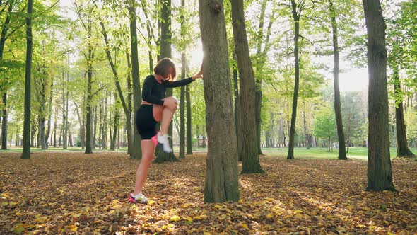 Attractive Woman Doing Fitness Exercises at Park alt