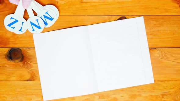 School teacher lays out a alphabet for learning spelling, notebook in an oblique line