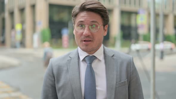 Middle Aged Businessman Talking on Online Video Call alt