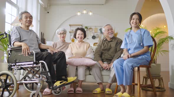 Group of Asian senior people in nursing home forming hands stack to build morale for yourself
