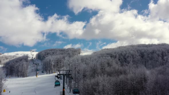 Aerial view at the ski slopes on a sunny winter day