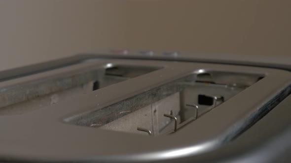 Slightly roasted bread popping up from toaster machine 4K 2160p UHD footage - Toasting bread in toas alt