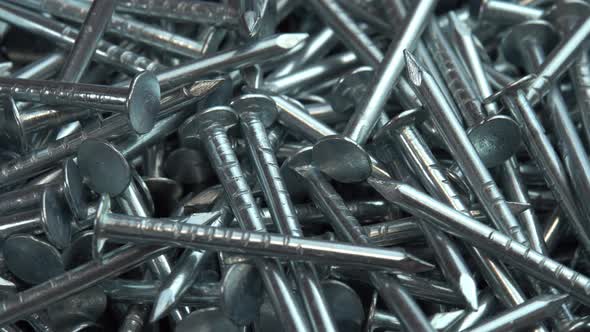 A Pile of Metallic Silver Nails for Construction Work Rotate As a Background Hobnails are Spinning alt