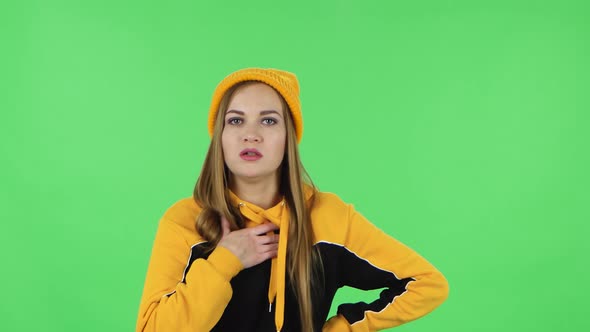 Portrait Modern Girl in Yellow Hat Is Cooling Herself By Her Hand, Suffering From High Temperature alt