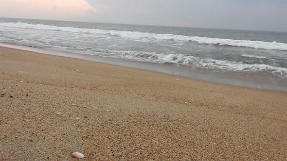 Cloudy beach, Ocean waves hitting shore in winter. Cloudy ocean waves in morning. sea waves. Ocean