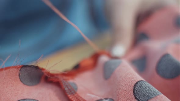 Closeup Hands of Seamstress at Work with Cloth Fabric alt