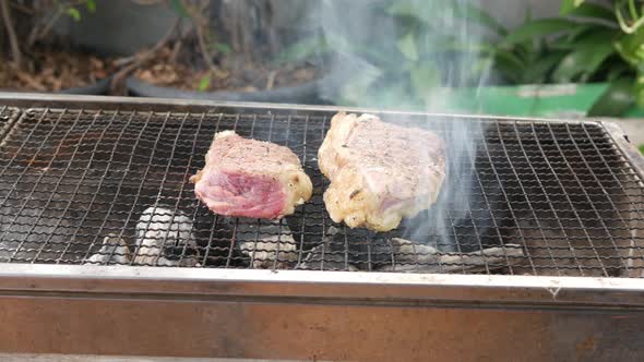 Grill the beef on the charcoal grill to cook steaks.