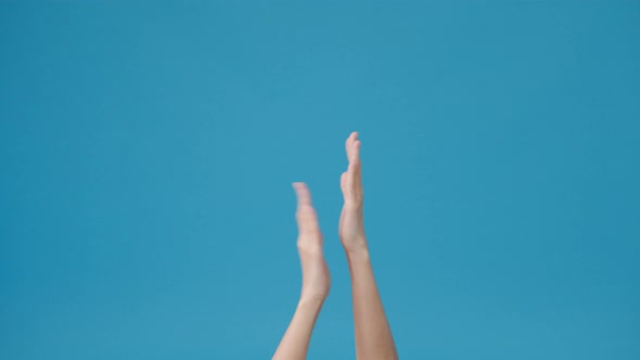 Young woman showing hand clapping applause isolated over blue background in studio.