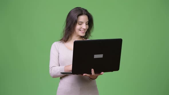 Young Happy Beautiful Woman Smiling While Using Laptop alt
