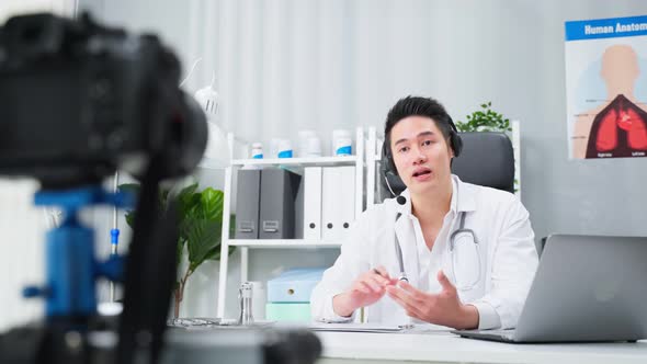 Asian male medical doctor talking virtual online with patient at home. alt