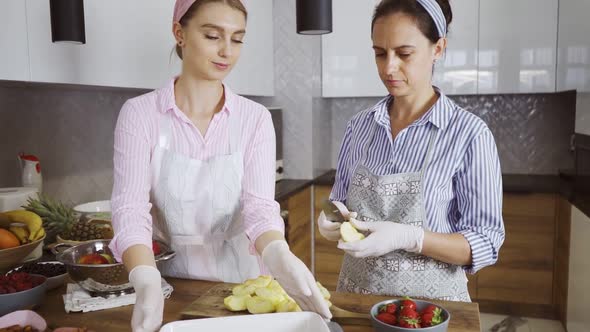 Women Using Apples for Cooking