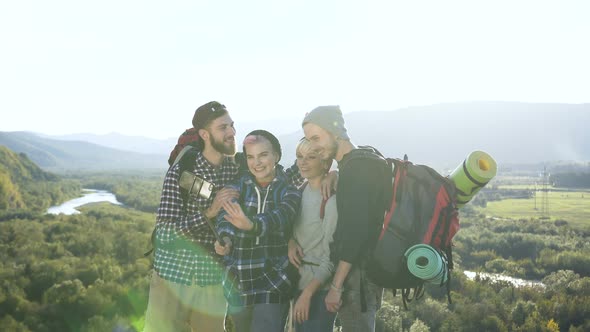 Two Couples Posing on the Smart Phone Camera in the Mountain alt