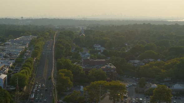 Aerial of a Small Town in Long Island and New York City Skyline Seen from Afar alt