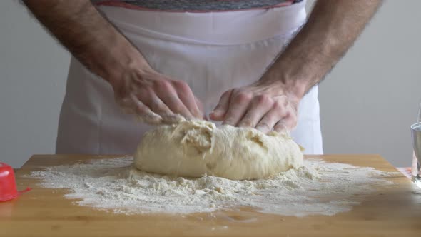 Man's hand preparing pizza dough