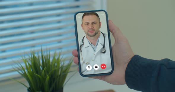 Man Checks Possible Symptoms with Professional Physician, Using Online Video Chat. Young Man Sick at alt