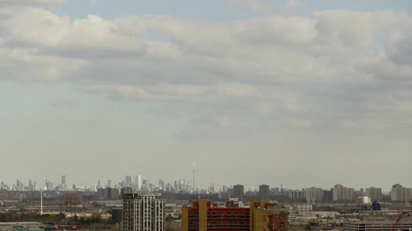 Clouds Moving In The Sky Over City Buildings And Toronto Skyline In The Distance In Canada. - timela alt