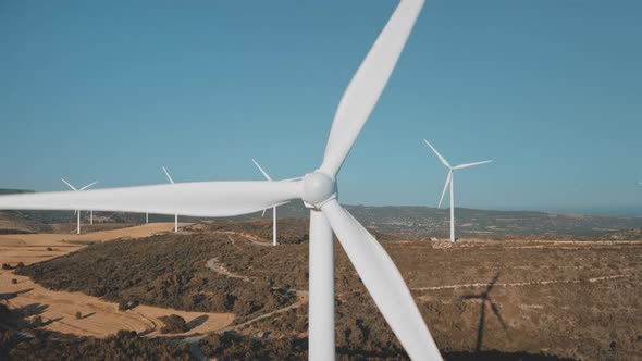 Wind Turbines Windmills Rotate Produce Green Alternative Electricity Energy in Field