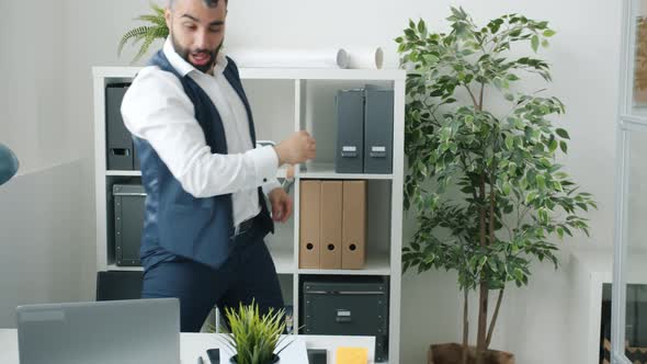 Cheerful Entrepreneur Working with Laptop Then Dancing Doing Highfive with Colleagues Celebrating alt