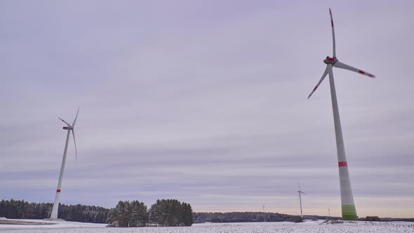 Time lapse of rotating wind turbines on a snowy field in Germany.