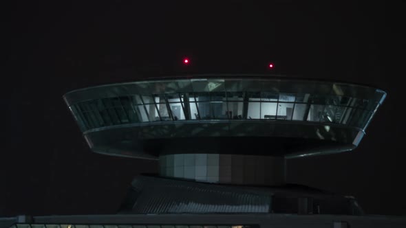 Time Lapse of Airport Control Tower with Red Lights at Night alt