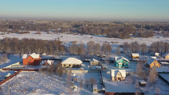 A Small Village in the Middle of a Pine Forest in Winter After Snowfall on a Bright Sunny Day