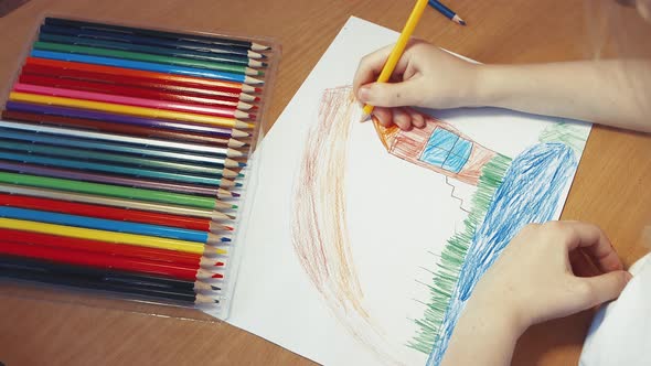 Children's Hands Draw a Road Next to the Lake House alt