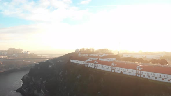 Aerial view of buildings on top of a cliff in Porto (Portugal) over Douro river. alt