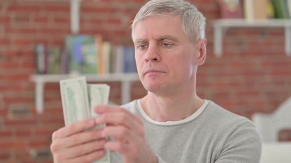 Wise Senior Old Man Counting Dollars alt