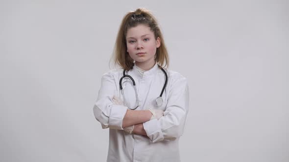 Serious Confident Little Doctor Crossing Hands Shaking Head Yes Looking at Camera alt