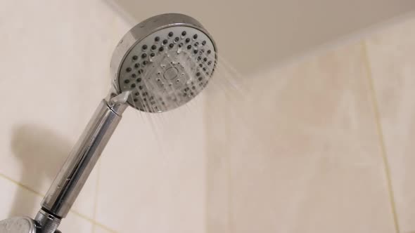 Close Up Shower Head with Water Dropping in Bathroom