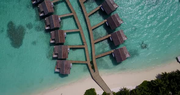 Luxury fly over tourism shot of a sunshine white sandy paradise beach and aqua blue ocean background alt
