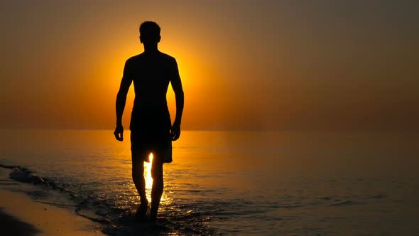 young man on the background of the sea sunset