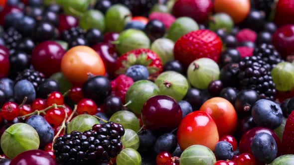 Texture of fresh wild forest berries on black background
